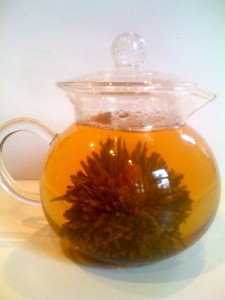 photo reveals flower tea in glass pot